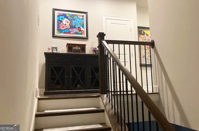 a view of entryway and hall with wooden floor