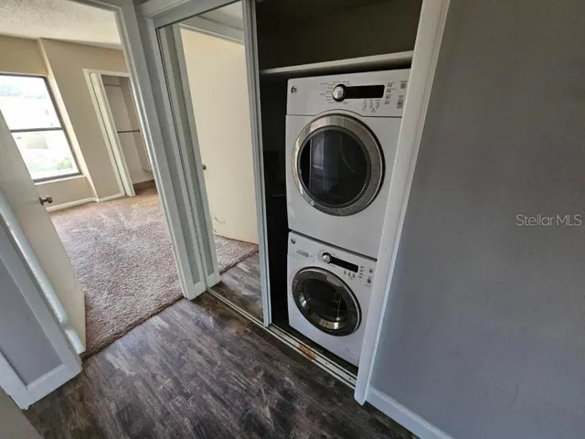 a view of a hallway with washer and dryer