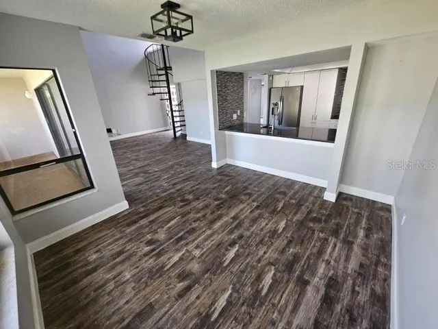 a view of an entryway with wooden floor