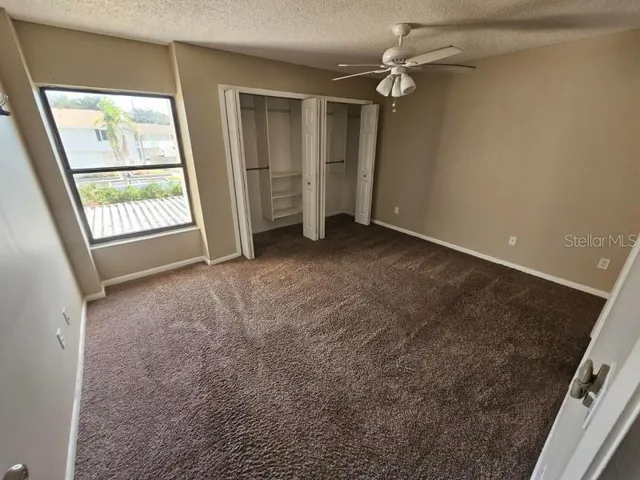 an empty room with windows and entrance