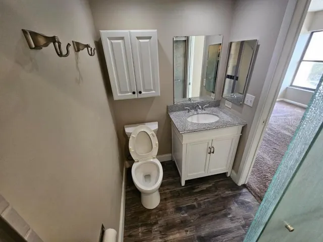 a bathroom with a granite countertop sink and a mirror