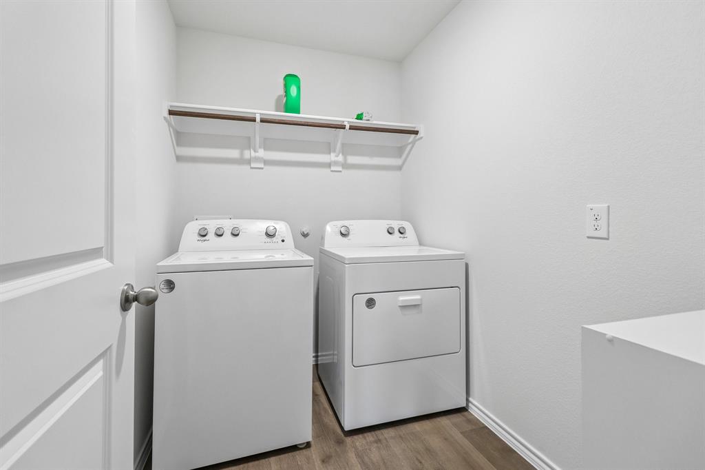 1453 Millstead Rill Road Caddo Mills, TX 75135 - Photo 35 of 40 Dedicated laundry area featuring wood-finish flooring, white walls, and a built-in storage shelf with hanging rod
