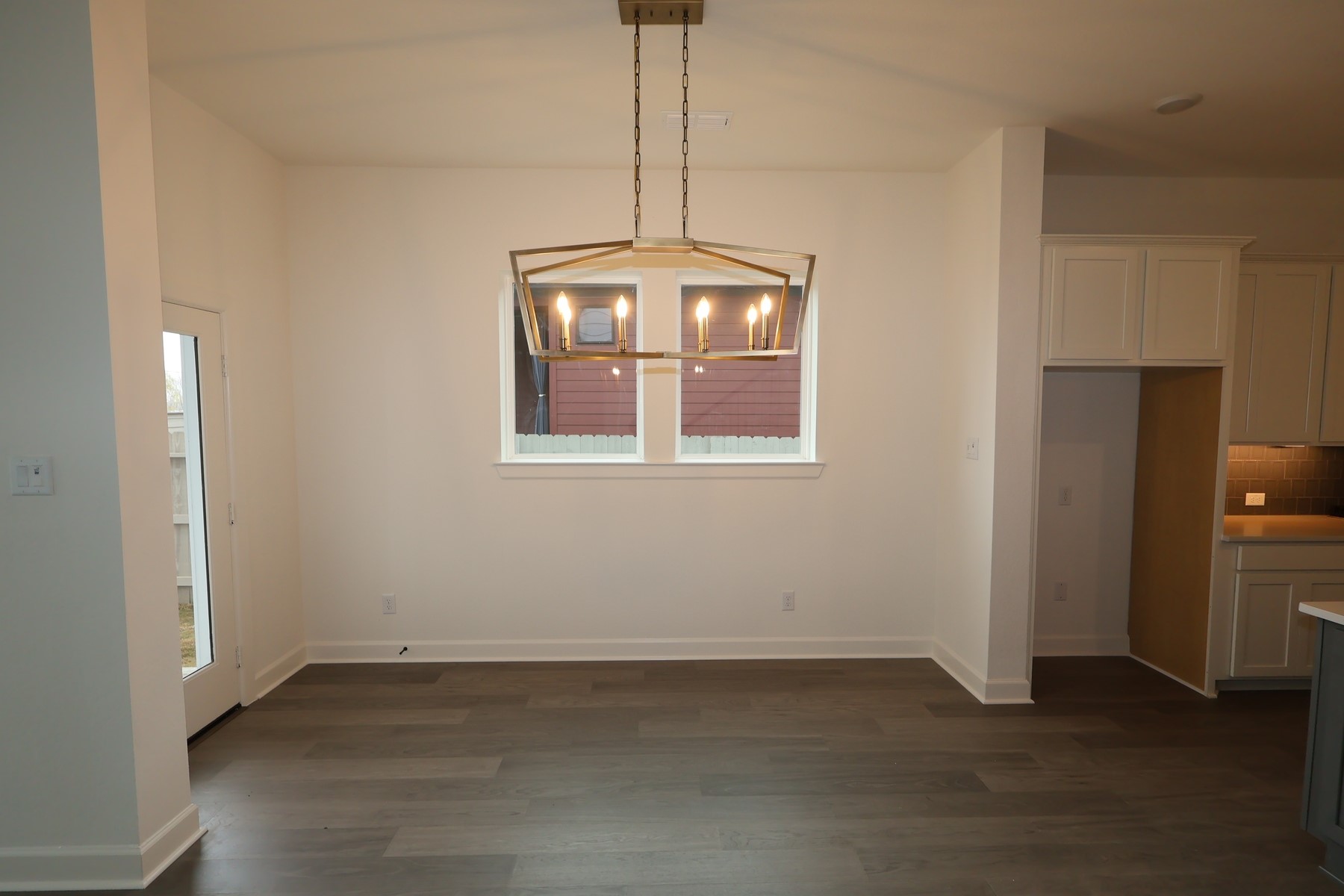 5614 Orangery Lane Manvel, TX 77578 - Photo 9 of 19 a view of an empty room with wooden floor and a window