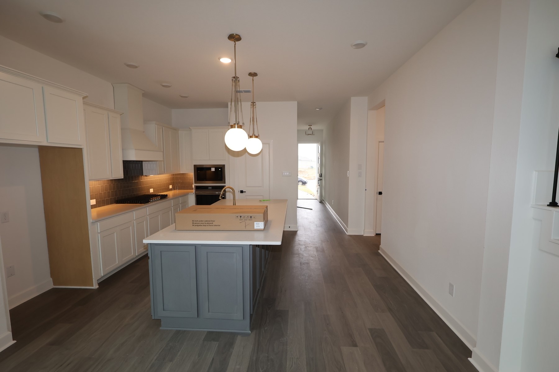5614 Orangery Lane Manvel, TX 77578 - Photo 7 of 19 a kitchen with a refrigerator a sink dishwasher a stove and white cabinets with wooden floor