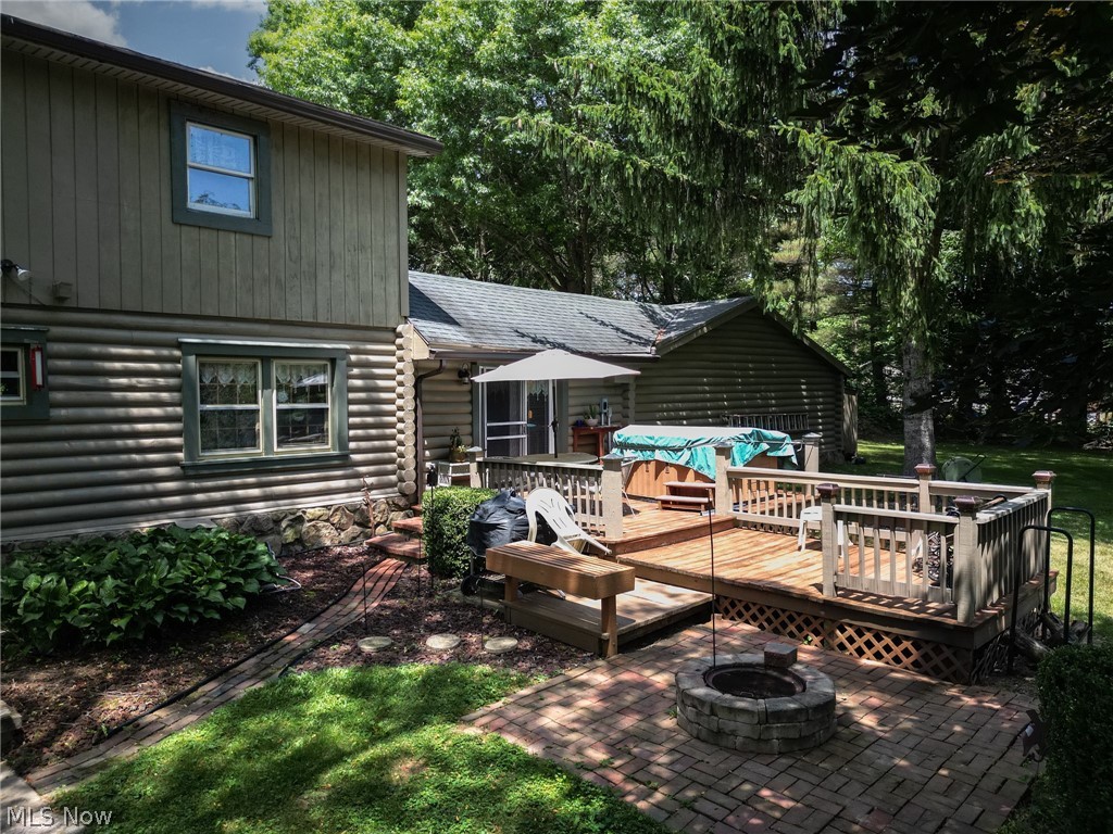 1070 Highland Ridge Road Lowell, OH 45744 - Photo 31 of 40 Back of property with a wooden deck, a patio area, and an outdoor fire pit