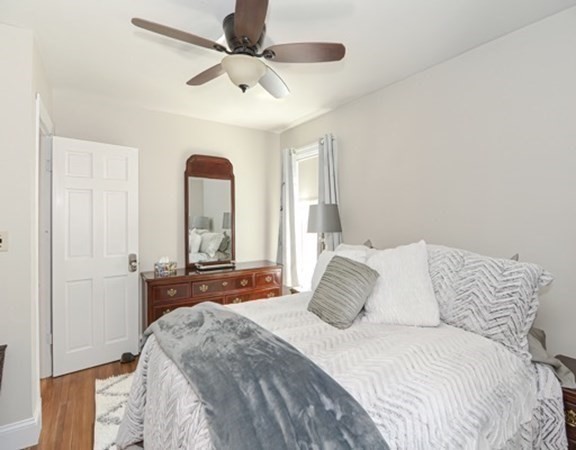 61 Arnold Road Quincy, MA 02171 - Photo 14 of 33 a bedroom with a large bed and a large window
