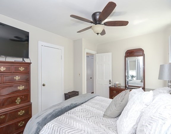 61 Arnold Road Quincy, MA 02171 - Photo 15 of 33 a bedroom with a bed and a chandelier