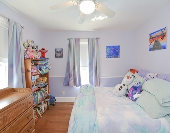 61 Arnold Road Quincy, MA 02171 - Photo 17 of 33 a bedroom with a bed and a chandelier