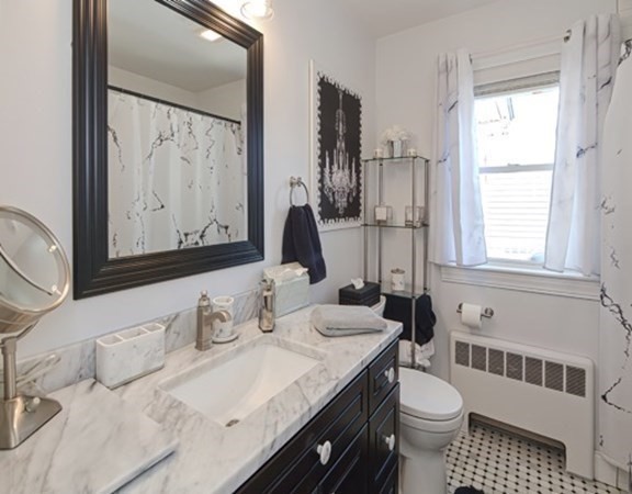 61 Arnold Road Quincy, MA 02171 - Photo 19 of 33 a bathroom with a granite countertop sink mirror vanity and toilet
