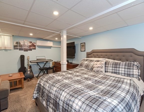 61 Arnold Road Quincy, MA 02171 - Photo 20 of 33 a bedroom with a bed and chair