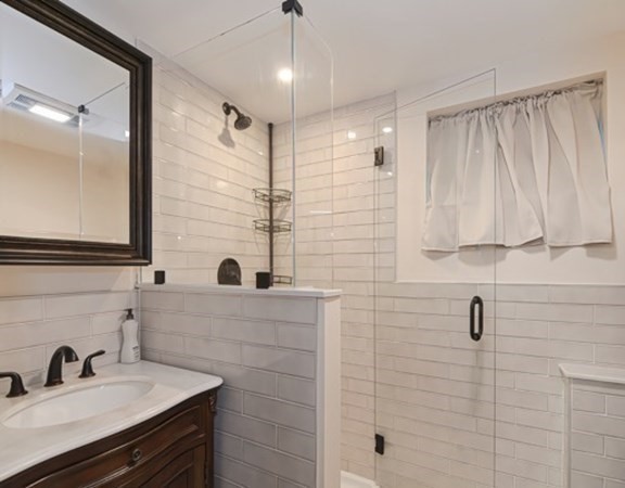 61 Arnold Road Quincy, MA 02171 - Photo 23 of 33 a bathroom with a sink and a mirror
