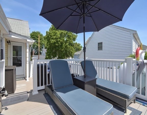 61 Arnold Road Quincy, MA 02171 - Photo 26 of 33 a view of a patio with a table and chairs under an umbrella
