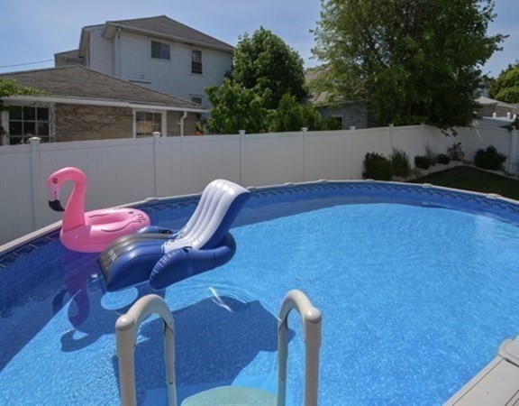 61 Arnold Road Quincy, MA 02171 - Photo 27 of 33 a front view of a house with table and chairs