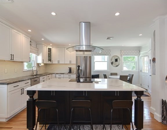61 Arnold Road Quincy, MA 02171 - Photo 7 of 33 a kitchen with a dining table chairs stainless steel appliances and cabinets