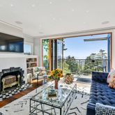 a living room with fireplace furniture and a flat screen tv