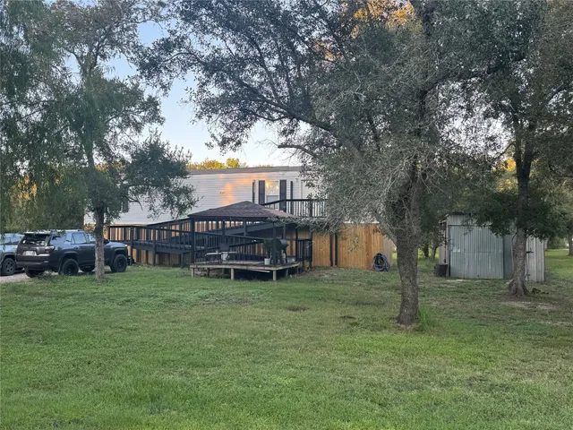a view of a house with a yard and sitting area