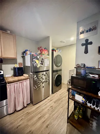 a kitchen with a refrigerator and a stove top oven