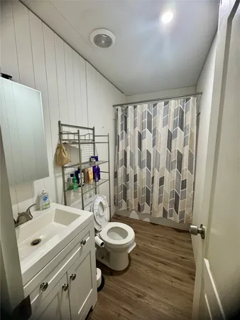 a bathroom with a sink toilet mirror and shower