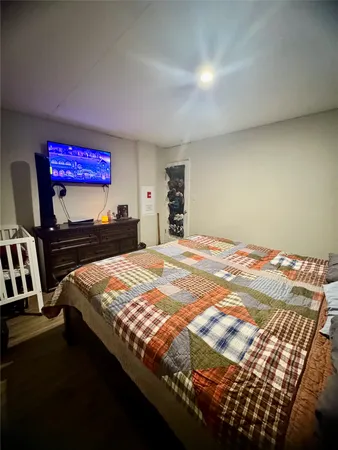 a bedroom with a bed and a dresser