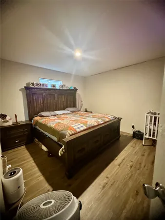 a bed sitting in a bedroom next to a larger window