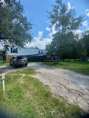 a view of a yard with a car parked
