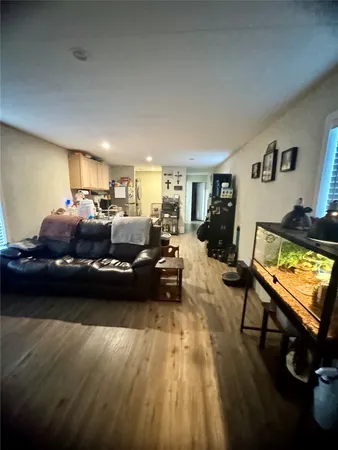 a living room with furniture window and wooden floor