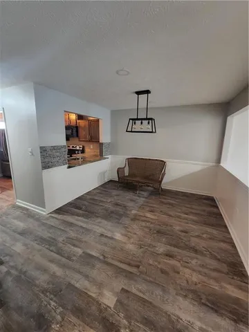 a view of a livingroom with furniture and a flat screen tv