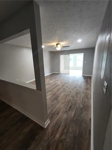 a view of a hallway with windows and stairs