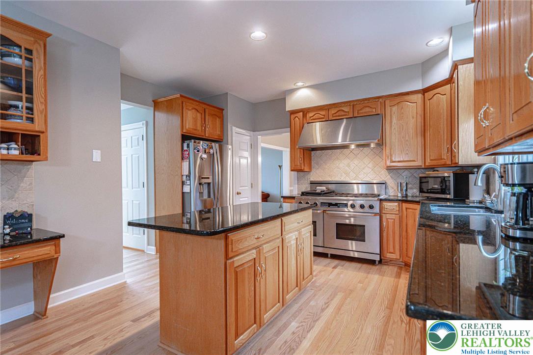 6551 Overlook Road Orefield, PA 18069 - Photo 23 of 82 a kitchen with stainless steel appliances granite countertop a stove and a refrigerator