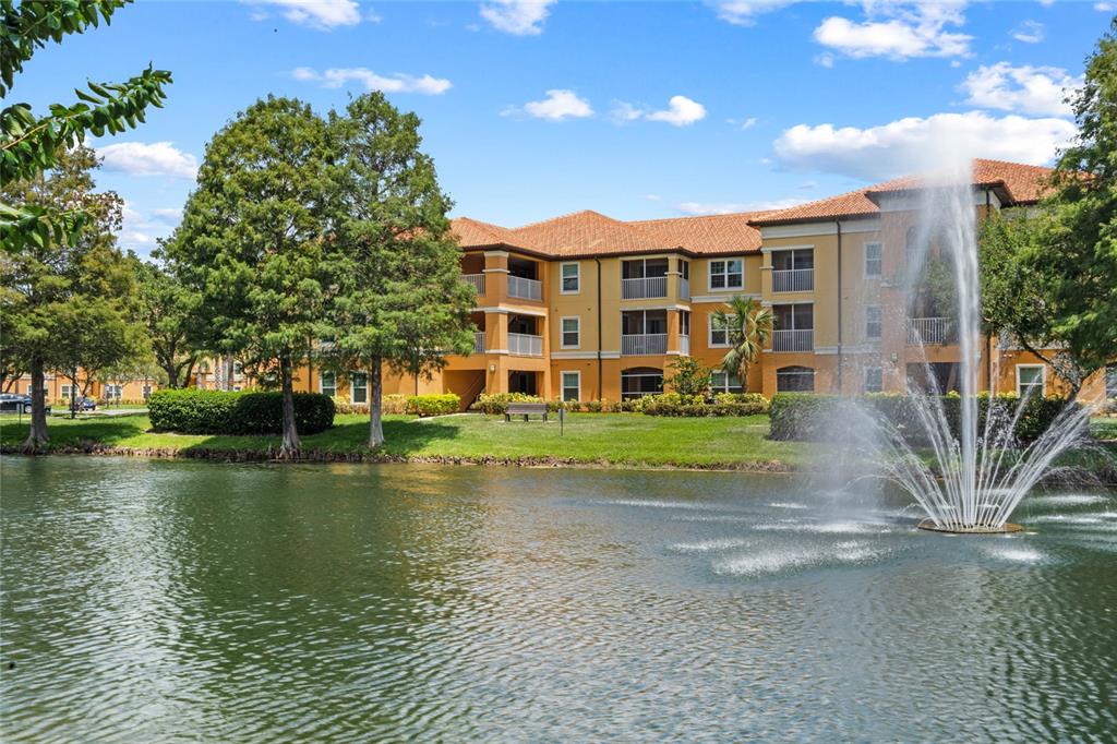 5467 Vineland Road, Unit 6313 Orlando, FL 32811 - Photo 1 of 1 a view of a brick house with a yard next to a lake