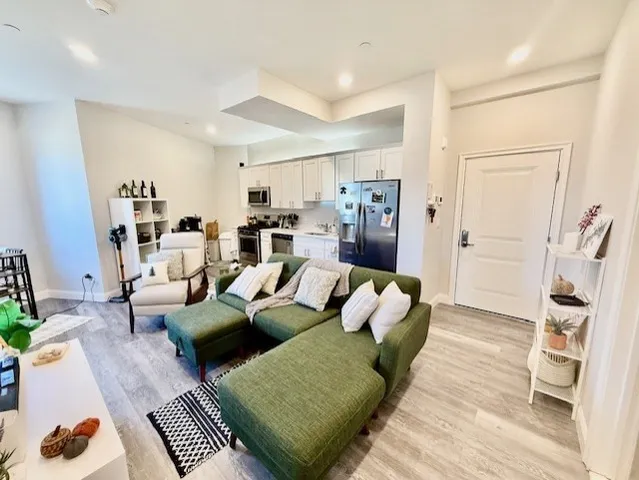 a living room with furniture and wooden floor