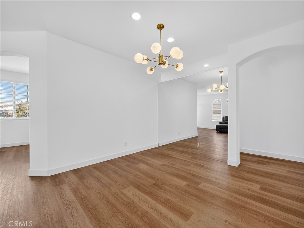 1436 Riviera Avenue Banning, CA 92220 - Photo 15 of 43 a view of an empty room with wooden floor