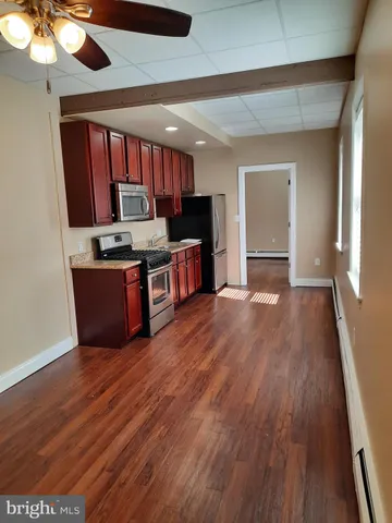 a view of kitchen with sink and wooden floor