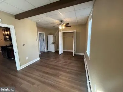 a view of a hallway with wooden floor and closet