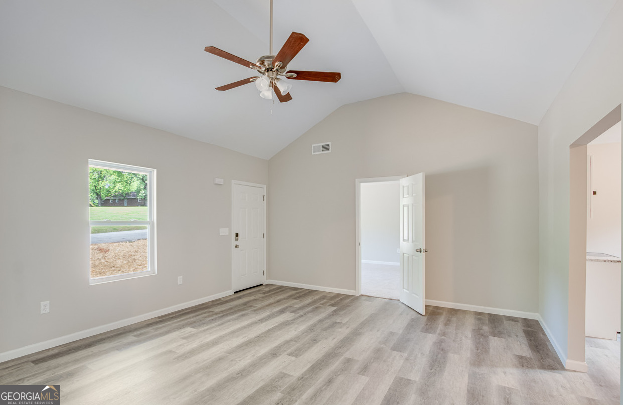 54 Lyla Lane Canon, GA 30520 - Photo 12 of 18 a view of a livingroom with a ceiling fan and window