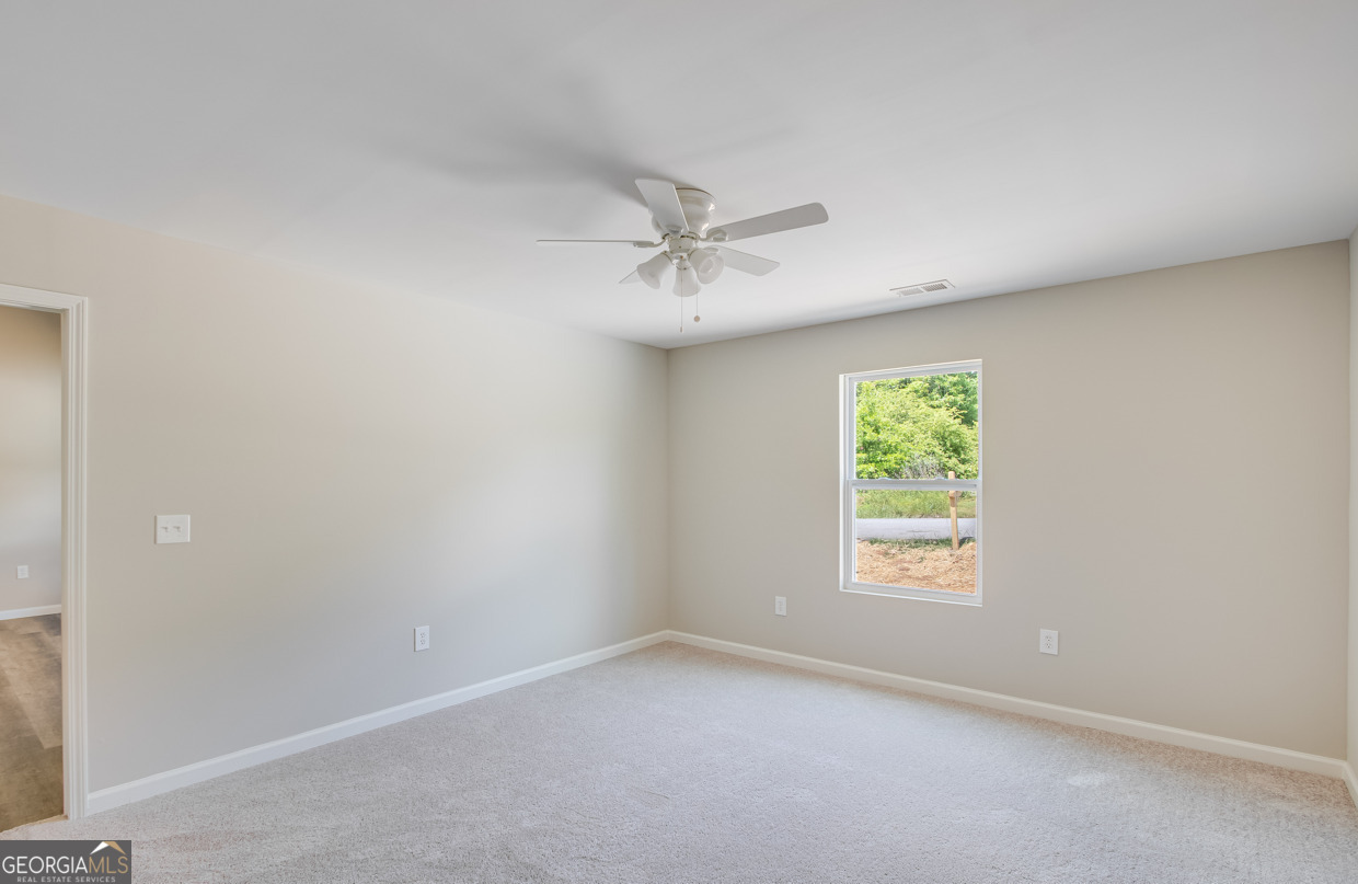 54 Lyla Lane Canon, GA 30520 - Photo 15 of 18 an empty room with a window and a fan
