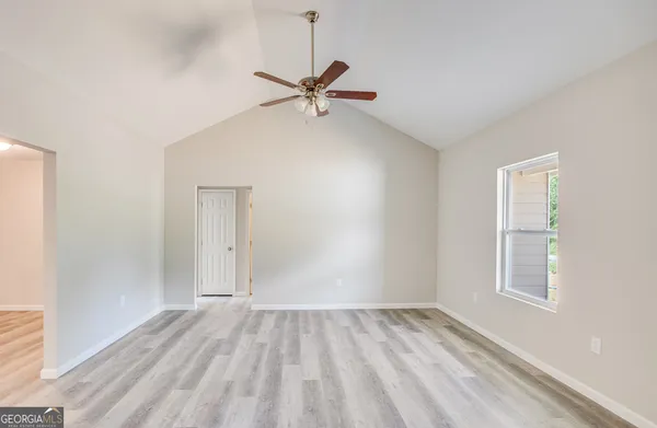 wooden floor in an empty room with a window