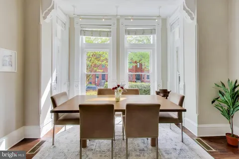a view of a dining room with furniture and window