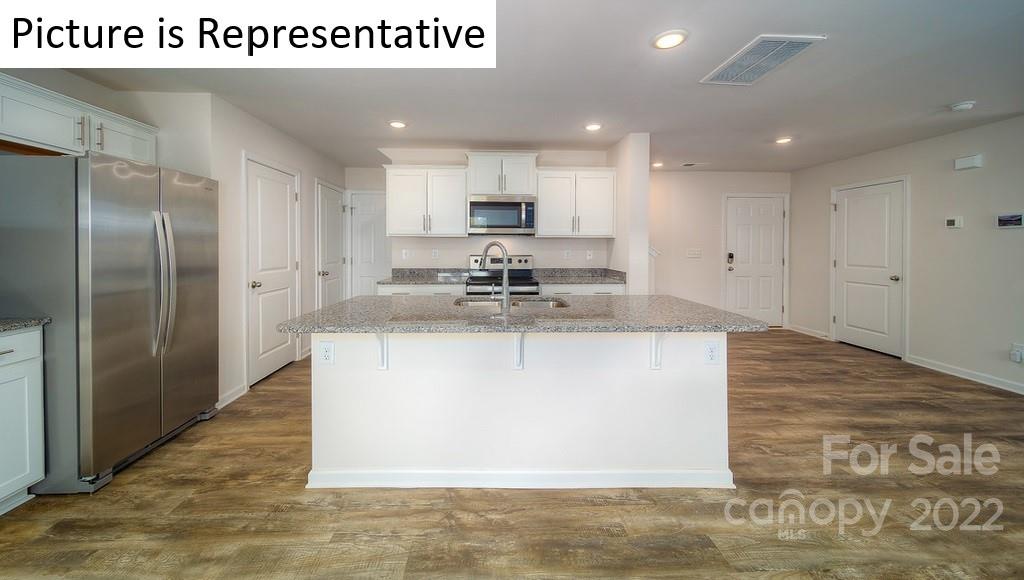 5034 Fandango Road York, SC 29745 - Photo 6 of 24 a kitchen with kitchen island stainless steel appliances sink refrigerator and microwave
