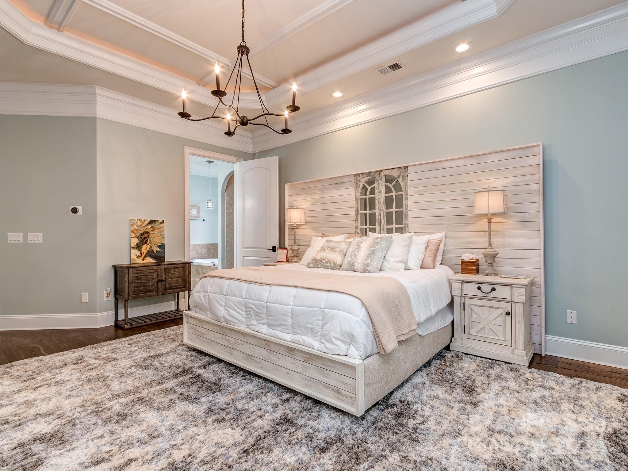 736 Cooks Cove Ridge Clover, SC 29710 - Photo 17 of 40 a spacious bedroom with a bed and a chandelier