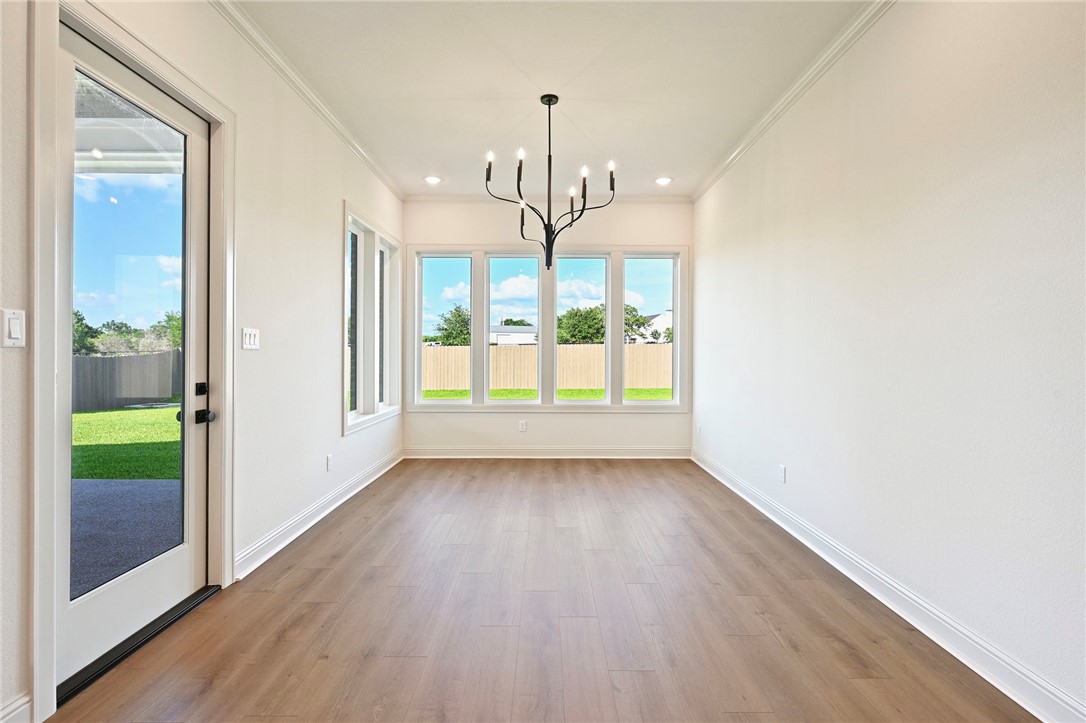 7052 Skipping Rock Path Bryan, TX 77808 - Photo 8 of 23 a view of an empty room with wooden floor and a window