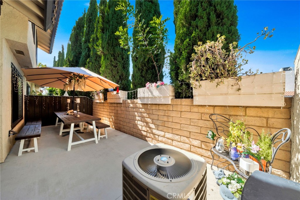 5151 Walnut Avenue, Unit 34 Irvine, CA 92604 - Photo 12 of 38 a backyard of a house with table and chairs