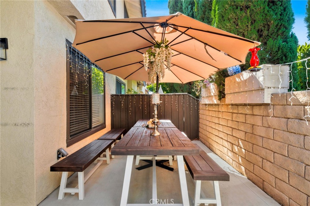 5151 Walnut Avenue, Unit 34 Irvine, CA 92604 - Photo 13 of 38 a backyard of a house with table and chairs
