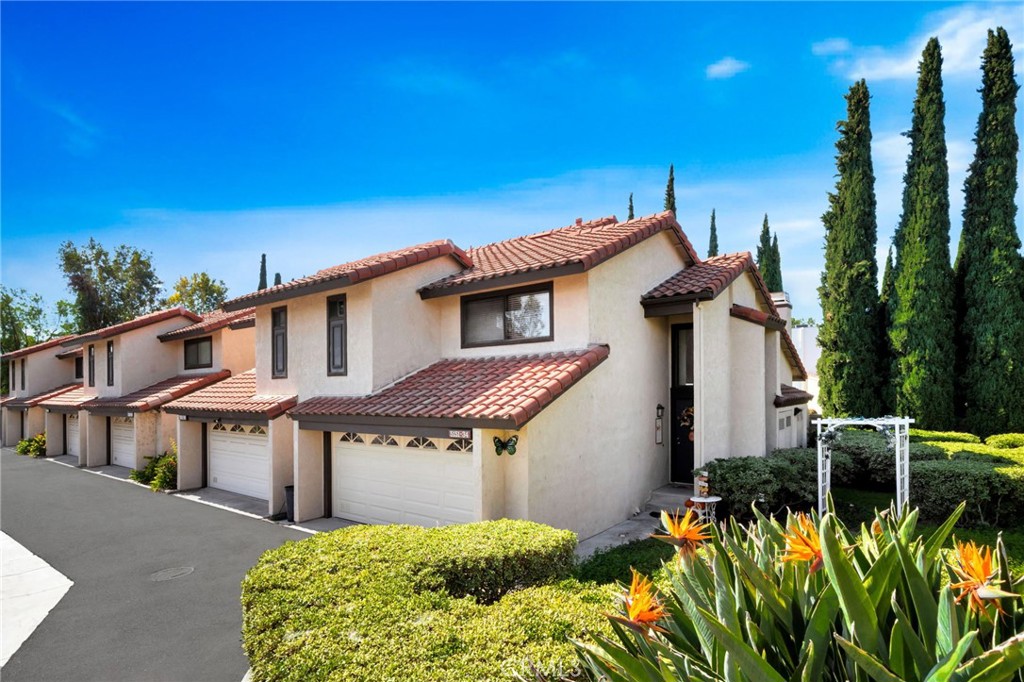 5151 Walnut Avenue, Unit 34 Irvine, CA 92604 - Photo 2 of 37 a front view of a house with a yard