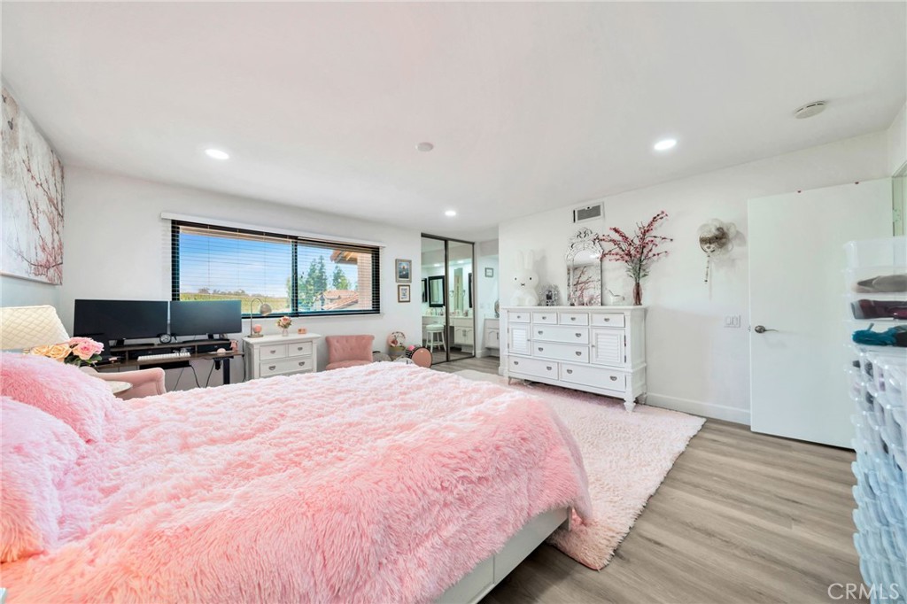 5151 Walnut Avenue, Unit 34 Irvine, CA 92604 - Photo 22 of 38 a spacious bedroom with a large bed and a flat tv screen on dresser