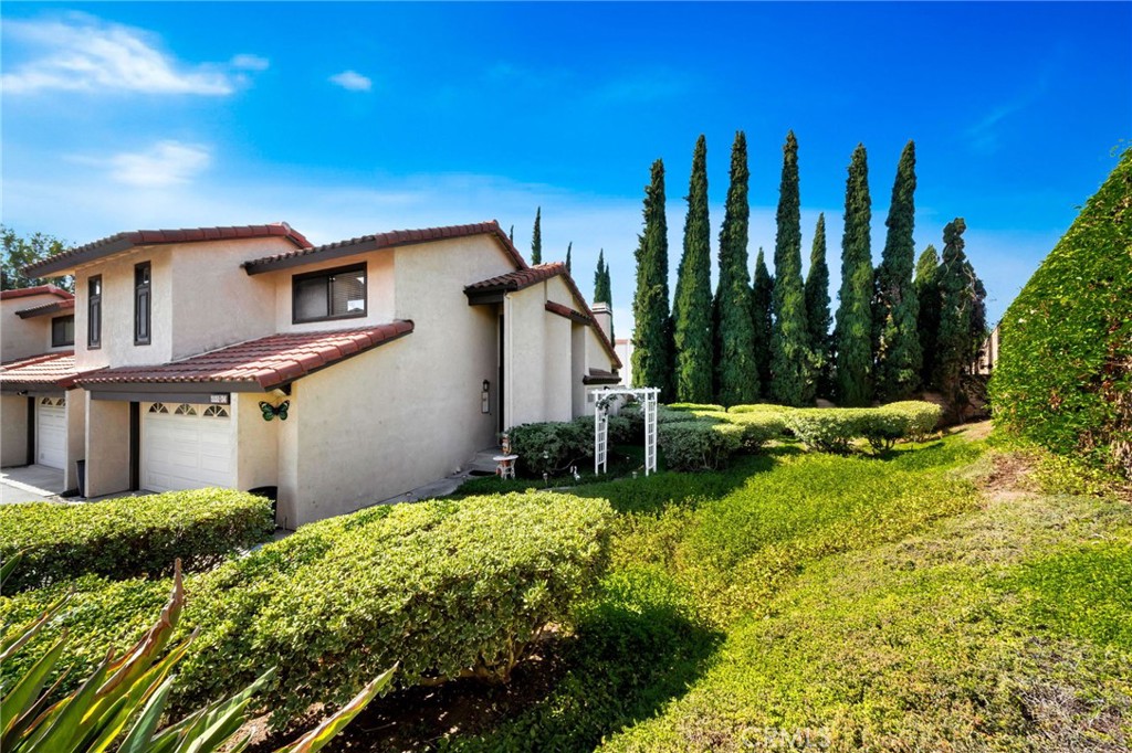 5151 Walnut Avenue, Unit 34 Irvine, CA 92604 - Photo 31 of 37 a front view of a house with garden