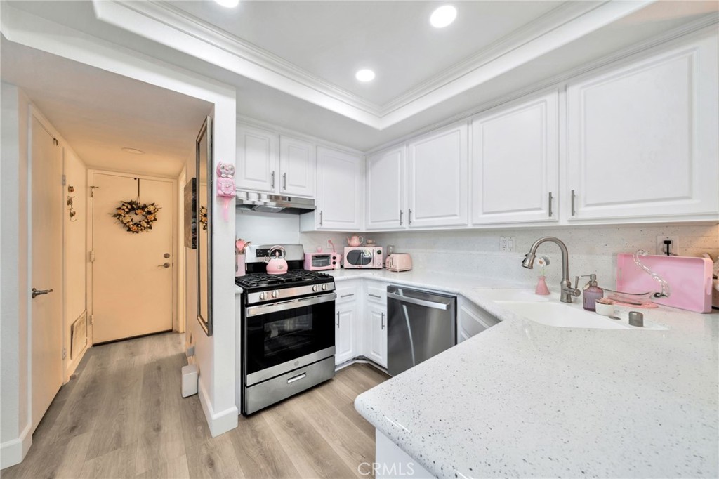 5151 Walnut Avenue, Unit 34 Irvine, CA 92604 - Photo 7 of 38 a kitchen with a sink a stove and refrigerator