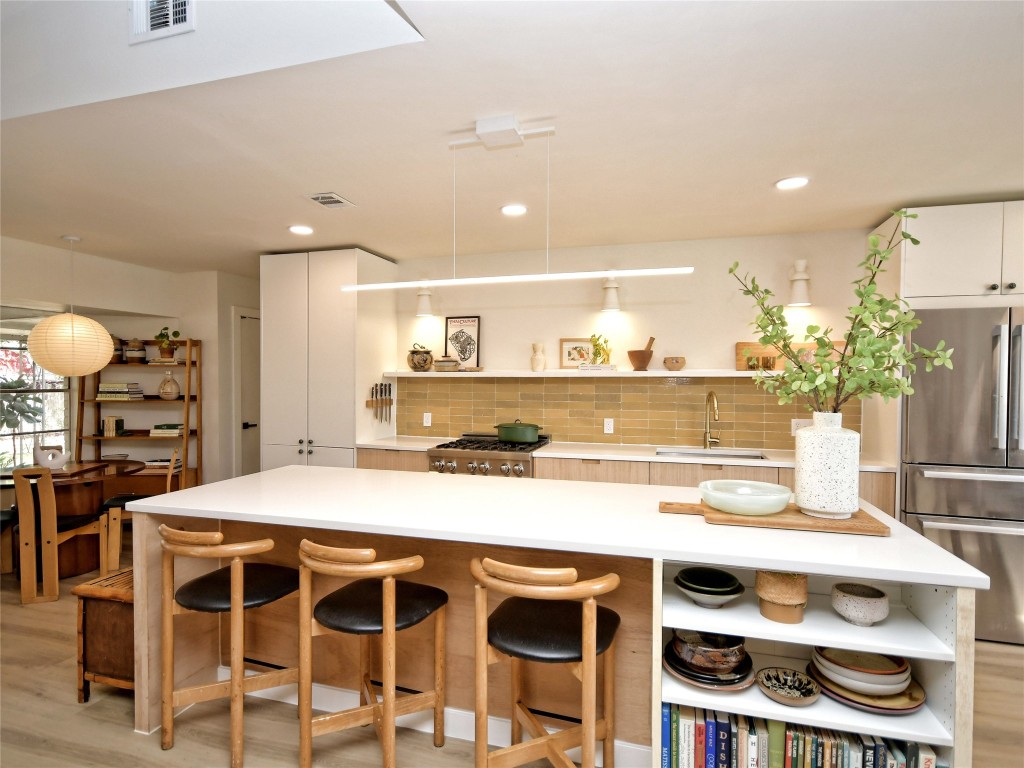 a kitchen with a table and chairs in it