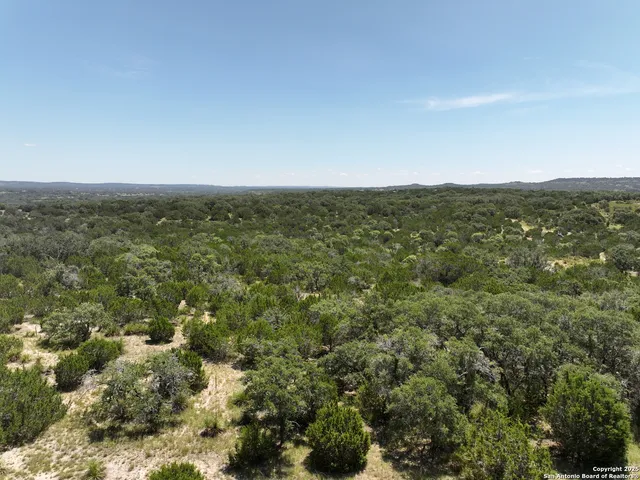an aerial view of residential houses with city view