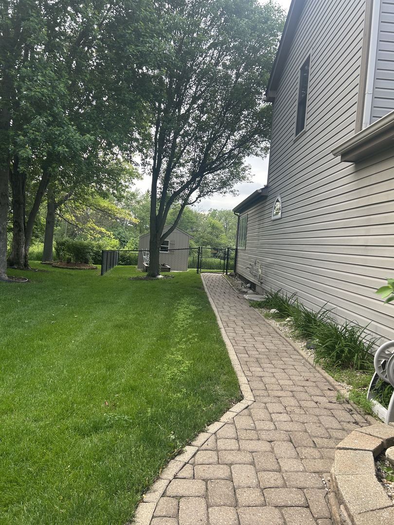 527 Springwood Lane Bolingbrook, IL 60440 - Photo 29 of 35 a view of a backyard with a large tree
